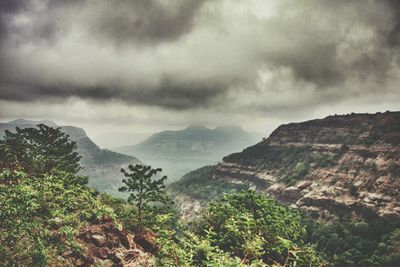 Scenic view of mountains against cloudy sky