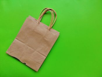 High angle view of paper against green background