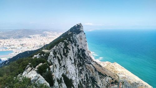 Scenic view of sea and mountains against sky