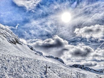 Scenic view of snow covered mountains against sky