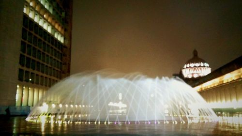 Reflection of illuminated built structure in water