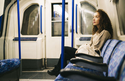 Contemplative woman sitting in subway train