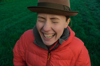 Portrait of laughing woman on field