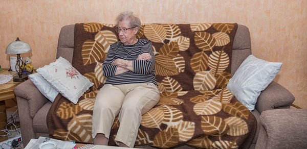 Men sitting on sofa at home