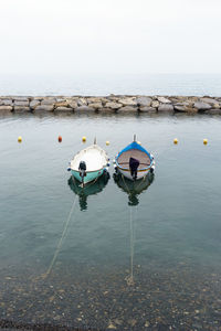 Two boats in sea against sky