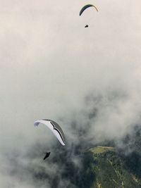 Person paragliding against sky