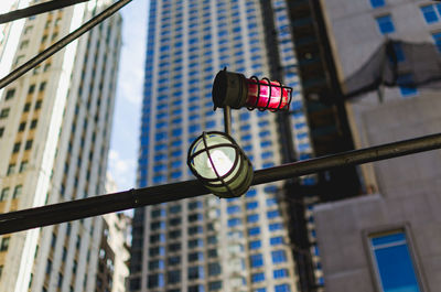 Low angle view of illuminated lamp in city