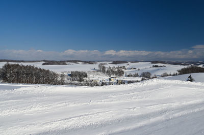 Scenic view of snow covered mountains against clear sky