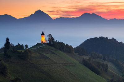 Scenic view of landscape against mountain during dusk