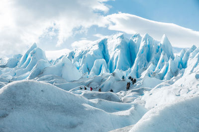 Snow covered landscape against sky