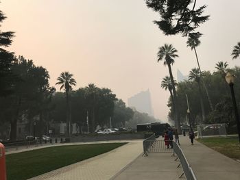 People riding bicycle on street in foggy weather