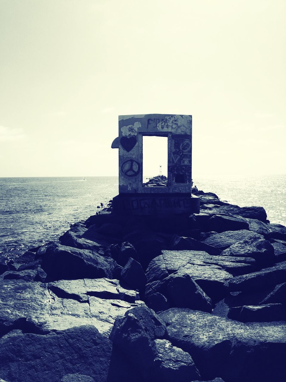 sea, horizon over water, water, clear sky, built structure, architecture, sky, old, building exterior, history, copy space, rock - object, abandoned, nature, tranquility, outdoors, the past, scenics, day, stone material