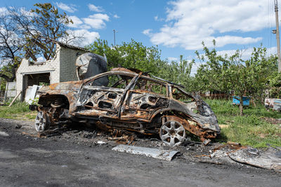Burned and broken car. war in ukraine 2022. russian missiles in kharkiv ukraine. russian aggression