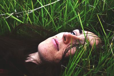 Portrait of woman lying on grass