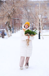 Rear view of woman standing in snow