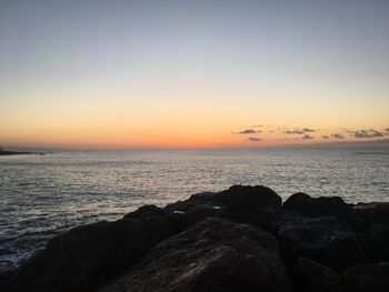 Scenic view of sea against clear sky during sunset