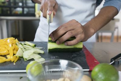 Midsection of man preparing food in kitchen