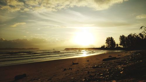 Scenic view of beach against sky during sunset