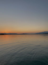 Scenic view of sea against clear sky during sunset