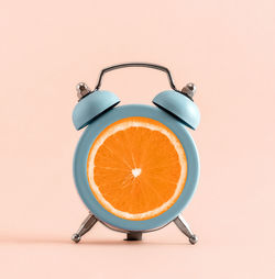 High angle view of clock on yellow background