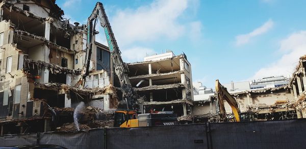 Low angle view of construction site against buildings in city