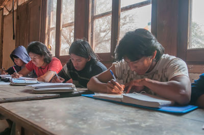 People in book on table