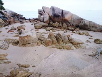 Rocks on beach against sky