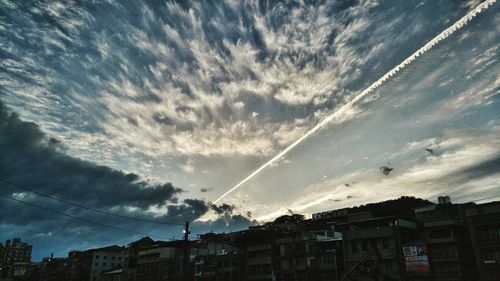 Low angle view of building against cloudy sky