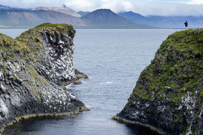 Scenic view of sea and mountains against sky