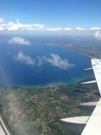 Cropped image of airplane wing over landscape