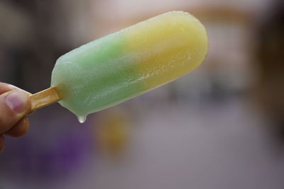 Close-up of hand holding ice cream cone