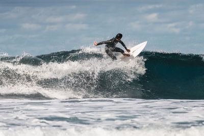 Man surfing waves in atlantic ocean, tenerife, spain