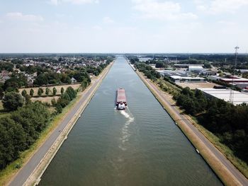 High angle view of canal amidst sea against sky