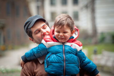 Portrait of father and son during winter