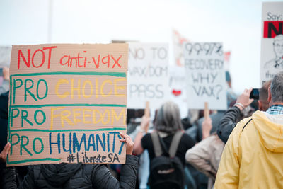 Rear view of man with text on street