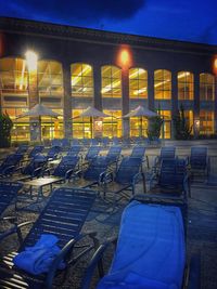 Empty chairs and tables at night