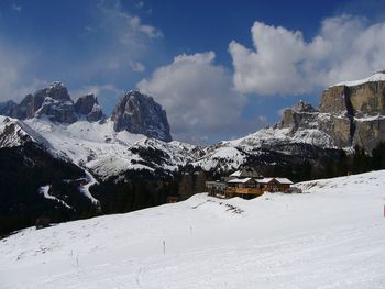 Scenic view of snowcapped mountains against cloudy sky