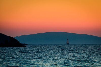 Scenic view of sea against orange sky