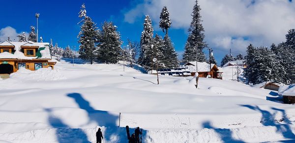 Panoramic view of snow covered land against sky