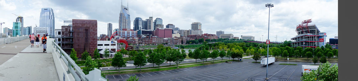 Modern buildings against cloudy sky