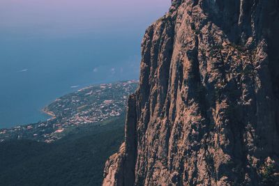 Scenic view of rocky mountain above beach landscape