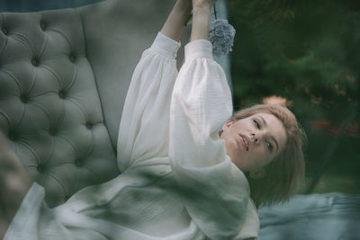 Portrait of a smiling young woman lying down