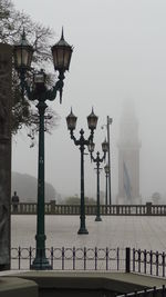 Lamp posts on footpath at plaza san martin during foggy weather