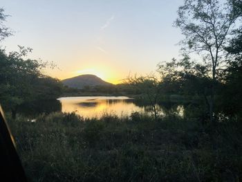 Scenic view of lake against sky during sunset