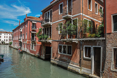 Buildings in front of the canal with gondola in venice, italy.