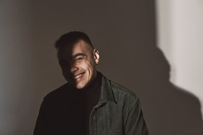 Portrait of happy man against white background in studio