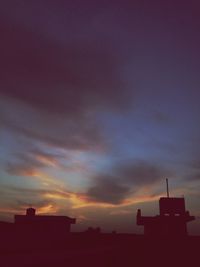 Low angle view of built structure against dramatic sky