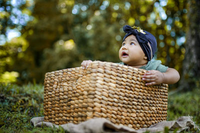 Cute boy looking away in basket