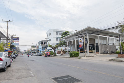 City street by buildings against sky