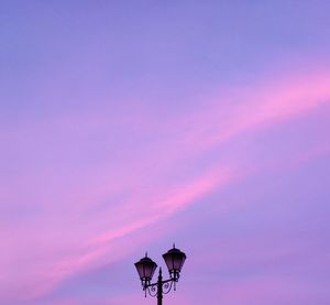 Low angle view of street light against sky during sunset